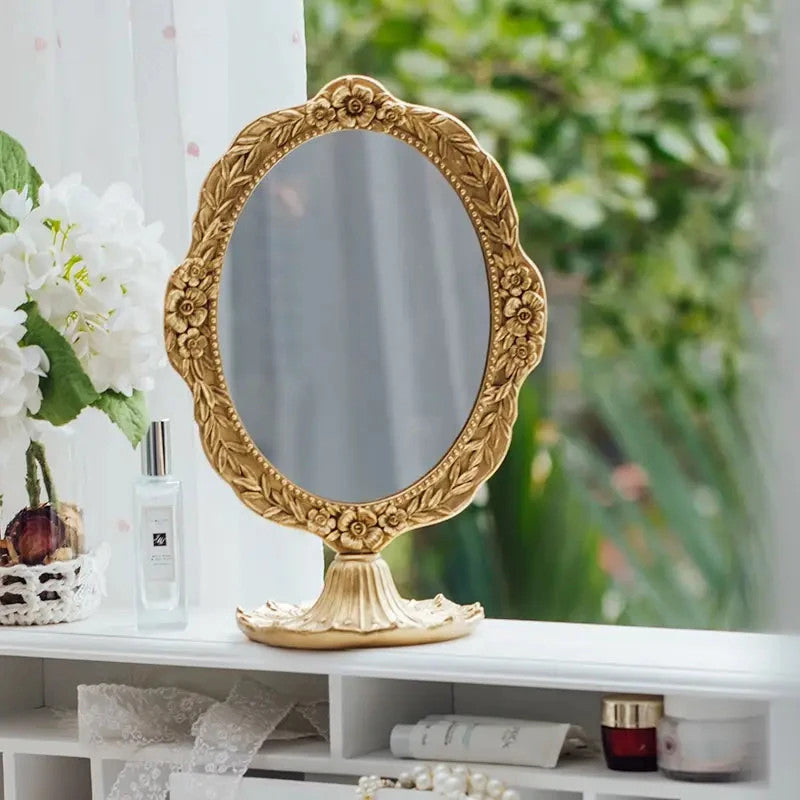Elegant vintage gold resin vanity mirror with ornate detailing and pedestal base. Perfect for dressing tables and romantic décor styling