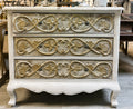 Three-tier French-style carved chest in distressed ivory finish with gold relief detailing and cabriole legs