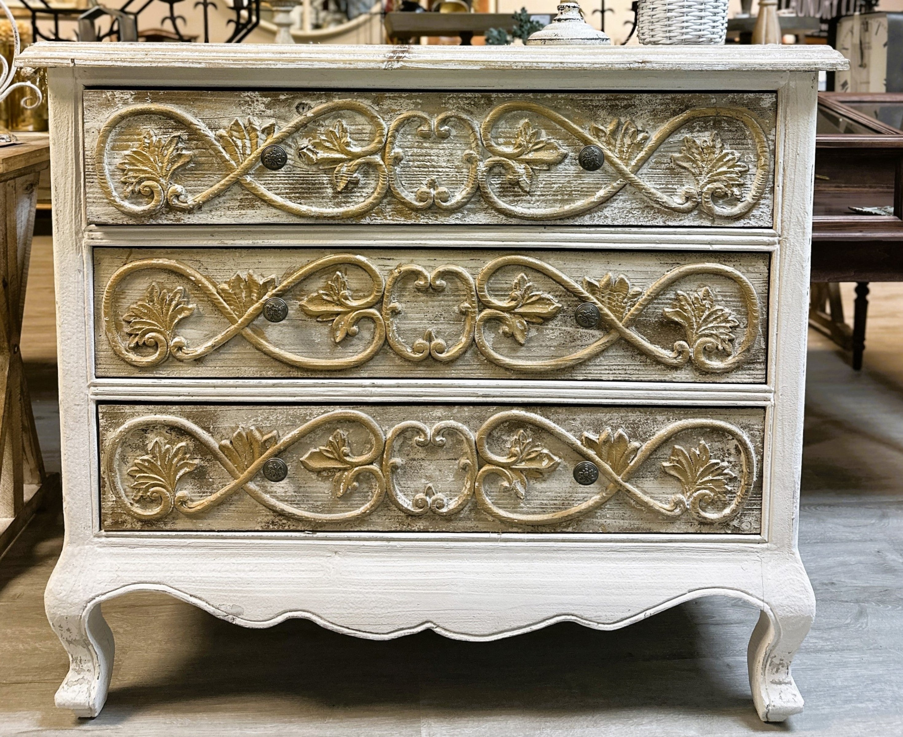Three-tier French-style carved chest in distressed ivory finish with gold relief detailing and cabriole legs